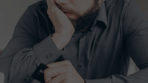 Man pondering and disgruntled looking at