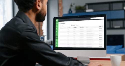 A fundraiser using the Rafflebox Dashboard on a computer to export their past ticket buyer list